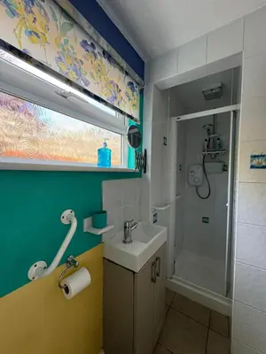 a bathroom with a sink and a shower at Sherrington Cottage 1 minute walk to Frintons blue flag beach Sleeps up to 8 in Frinton-on-Sea