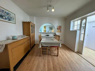 a kitchen with a table and chairs in a room at Sherrington Cottage 1 minute walk to Frintons blue flag beach Sleeps up to 8 in Frinton-on-Sea