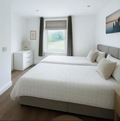 a white bedroom with a large bed and a window at Weekday Special - 4BDR House By Homestyles Hosts Short Lets & Serviced Accommodation Ipswich Near Town Centre With Free Parking in Ipswich