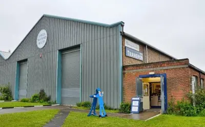 a person walking in front of a building at Weekday Special - 4BDR House By Homestyles Hosts Short Lets & Serviced Accommodation Ipswich Near Town Centre With Free Parking in Ipswich