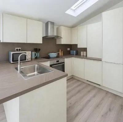a kitchen with white cabinets and a sink at Weekday Special - 4BDR House By Homestyles Hosts Short Lets & Serviced Accommodation Ipswich Near Town Centre With Free Parking in Ipswich