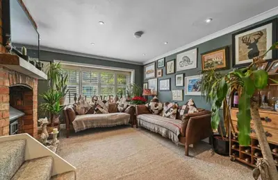 a living room with couches and a fireplace at A Beautiful Country Cottage in Waldringfield
