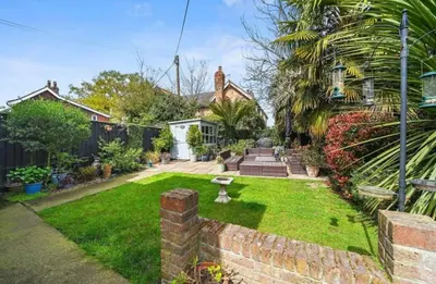 a house with a yard with a small garden at A Beautiful Country Cottage in Waldringfield
