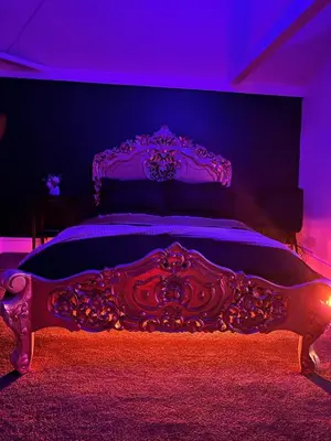 a bedroom with a bed with a purple lighting at Essex Dungeon Suite in Heybridge