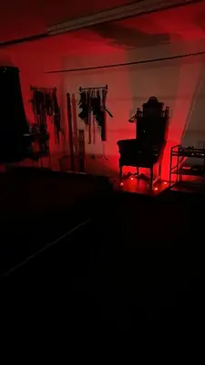 a room with a piano in a room with red lights at Essex Dungeon Suite in Heybridge