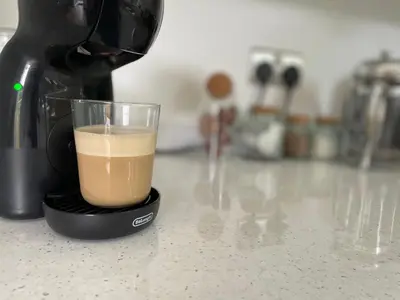 a cup of coffee sitting on top of a counter at 8 Iris Cottage 4-BR Coastal Home in Suffolk in Wenhaston