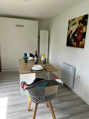 a kitchen with a table and a chair with a plate at Dolly Studio in Colchester