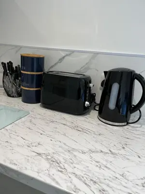 a microwave and a toaster sitting on a counter at Dolly Studio in Colchester