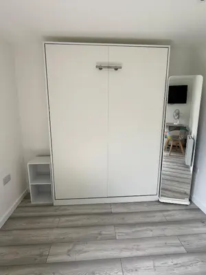 a large sliding glass door in a room at Dolly Studio in Colchester