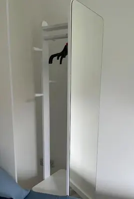 a glass cabinet with a mirror in a room at Dolly Studio in Colchester