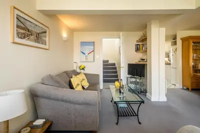 a living room with a couch and a table at 3 Bell Lodge - near Thorpeness Country Club and the beach - Aldeburgh Coastal Cottages in Thorpeness