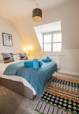 a bedroom with a large bed and a window at Gad About in Woodbridge
