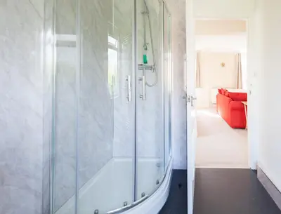 a shower with a glass door in a bathroom at Toothbrush Apartments - Ipswich East - Cauldwell Ave in Ipswich