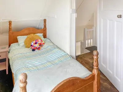 a wooden bed with a stuffed toy on it at Humperdink in Saint Osyth
