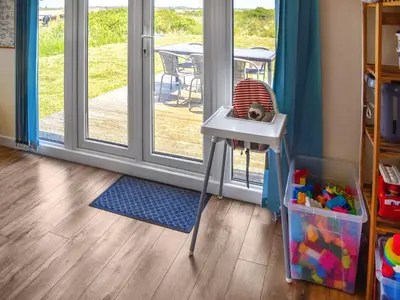 a room with a table and a chair and a door at Humperdink in Saint Osyth