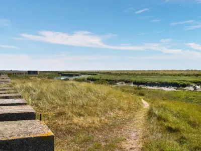 a path through a field with a river at Humperdink in Saint Osyth