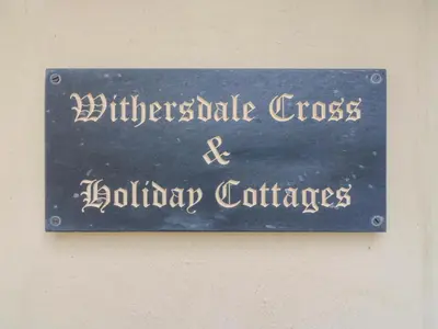 a sign on a wall that readsgraduate cross and holiday certificates at The Kiln in Harleston