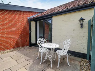 two chairs and a table on a patio at The Kiln in Harleston