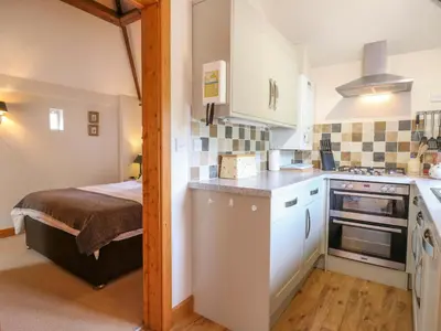 a small kitchen with a bed in a room at The Kiln in Harleston