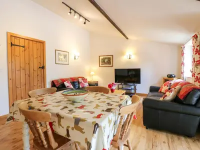 a living room with a table and a couch at The Golden Cross in Harleston