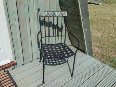 a black chair sitting on a deck at Oak Tree in Woodbridge