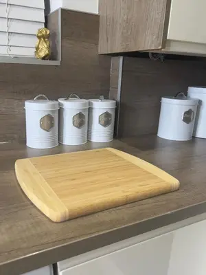 a wooden cutting board on top of a kitchen counter at Long Stay Basildon Essex Business Contractors in Basildon