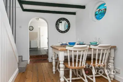 a dining room with a table and chairs at Saltmarsh Cottage in Brightlingsea