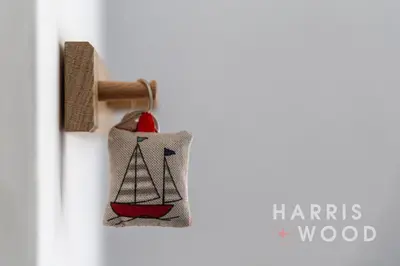 a door ornament of a sailboat on a door knob at Saltmarsh Cottage in Brightlingsea