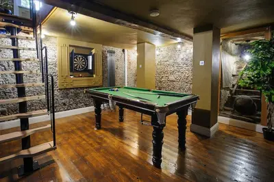 a billiard room with a pool table in it at Rock and Roll Suite In Manor House in Saffron Walden