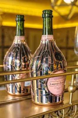 two bottles of wine sitting on a shelf at Rock and Roll Suite In Manor House in Saffron Walden