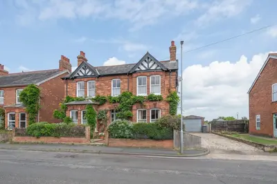 a red brick house with plants on it at 45 Carr Avenue, Leiston in Leiston