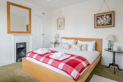 a bedroom with a bed and a fireplace at 45 Carr Avenue, Leiston in Leiston