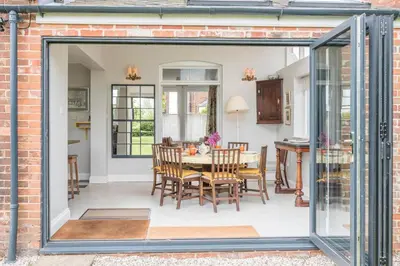 a kitchen and dining room with a sliding glass door at 45 Carr Avenue, Leiston in Leiston