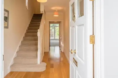 a hallway with stairs in a home at Cherry Tree House, Aldeburgh in Aldeburgh