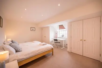 a bedroom with a bed and a desk in it at Cherry Tree House, Aldeburgh in Aldeburgh