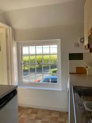 a kitchen with a window with a view of a car at The Coach House, Framsden