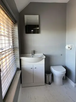 a bathroom with a sink and a toilet at The Coach House, Framsden