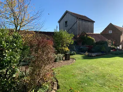 a house with a large barn in a yard at The Coach House, Framsden