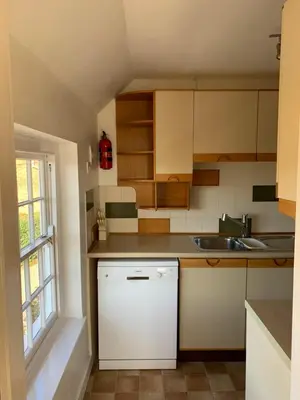 a small kitchen with a sink and a counter at The Coach House, Framsden