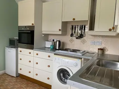 a kitchen with a washing machine and a sink at Little Furrows, Wenhaston in Wenhaston