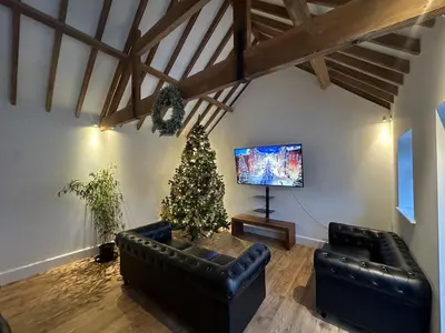 a living room with a christmas tree and a couch at Sleeps18 character barns in Old Hurst