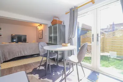 a room with a bed and a table and chairs at Gorgeous rural dog welcoming Milk Churn - Suffolk in Eye