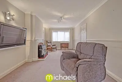 a living room with a chair and a flat screen tv at For Contractors, businesses, families - next to Colchester Royal Grammar School in Lexden