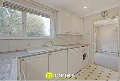 a kitchen with a sink and a washing machine at For Contractors, businesses, families - next to Colchester Royal Grammar School in Lexden
