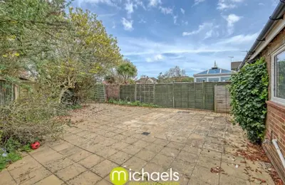 a backyard with a fence and a brick patio at For Contractors, businesses, families - next to Colchester Royal Grammar School in Lexden