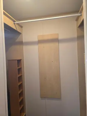 a closet with a wooden board on the wall at Sunny corner caravan in Saint Osyth