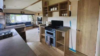 a kitchen with a stove and a counter top at Sunny Beach Holidays Home in Jaywick Sands