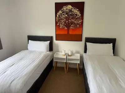 two beds sitting next to each other in a room at 3 bedrooms house in Stevenage