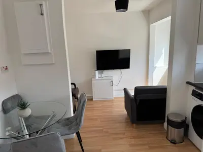 a living room with a glass table and a couch at 3 bedrooms house in Stevenage