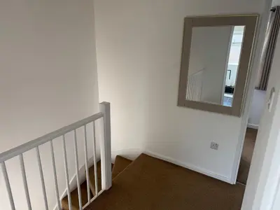 a stairway with a mirror on the wall at 3 bedrooms house in Stevenage